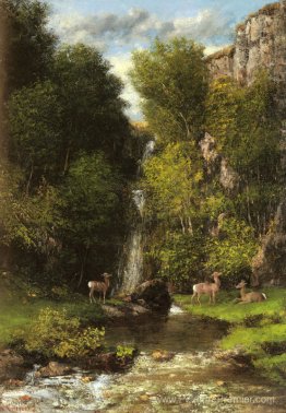 Une famille de cerfs dans un paysage avec une cascade